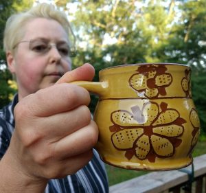 Photo of Anna Murfin holding a mug she created